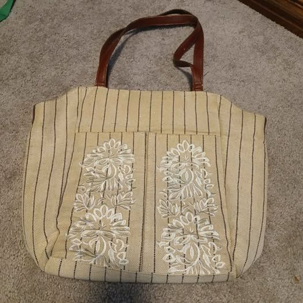 beige and black striped tote bag featuring white floral embroidery